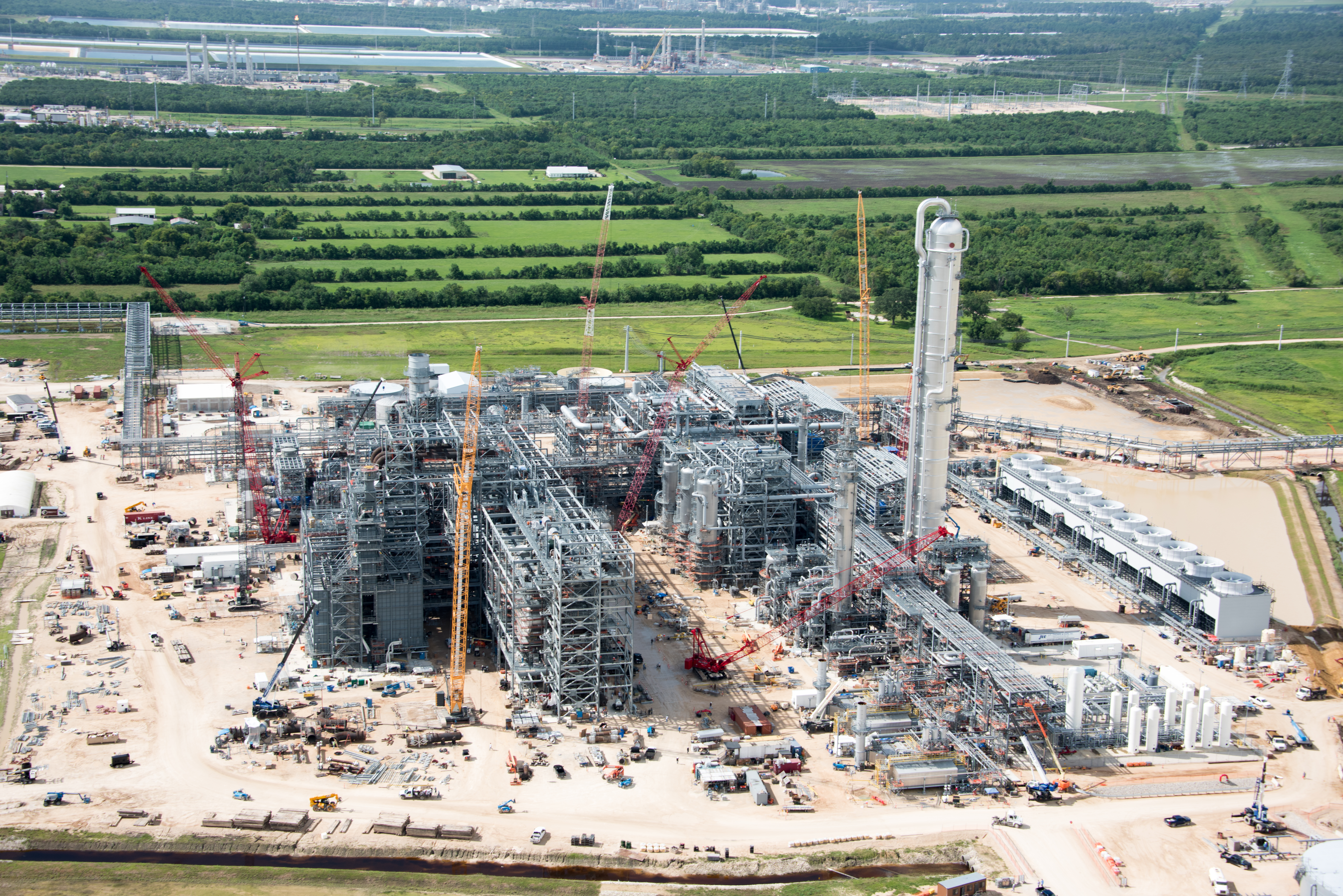Ongoing construction of an isobutane dehydrogenation unit featuring several large pieces of construction equipment.